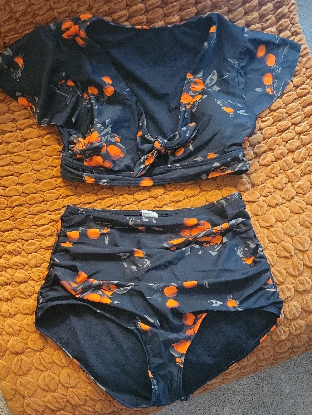 Black Two-Piece Swim Set with Orange Print.
